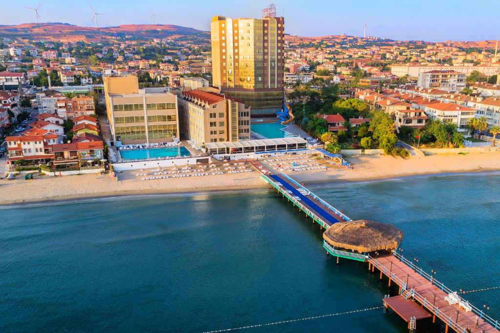 an aerial view of a beach with a pier and buildings at Kumburgaz Marin Princess Hotel in Büyükçekmece