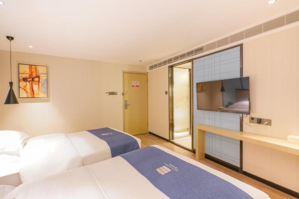 Postel nebo postele na pokoji v ubytování Echarm Hotel - Xiamen Zhongshan Road Pedestrian Street Branch