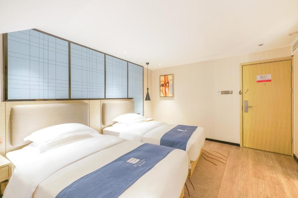 Postel nebo postele na pokoji v ubytování Echarm Hotel - Xiamen Zhongshan Road Pedestrian Street Branch