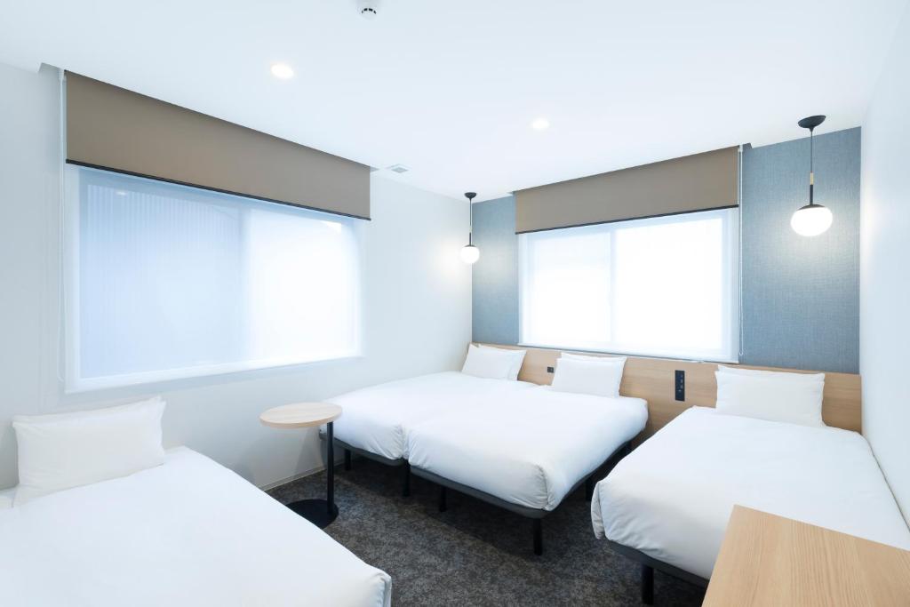 Postel nebo postele na pokoji v ubytování M's Hotel Sanjo Omiya