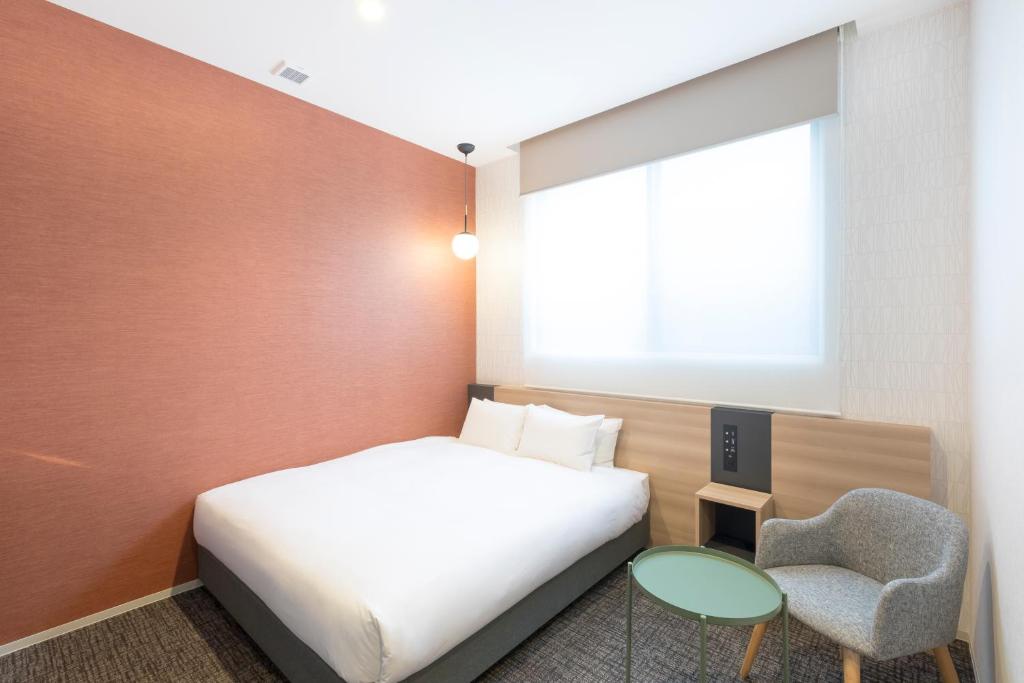 Postel nebo postele na pokoji v ubytování M's Hotel Sanjo Omiya