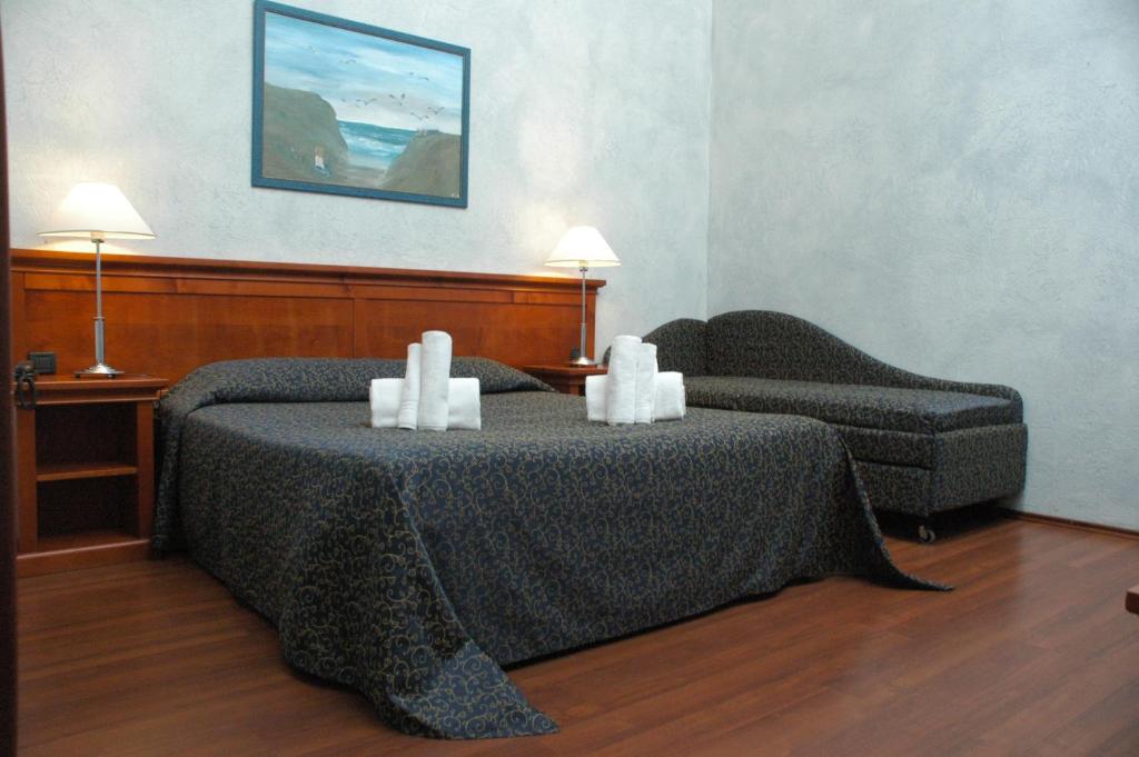 Postel nebo postele na pokoji v ubytování Hotel Clari