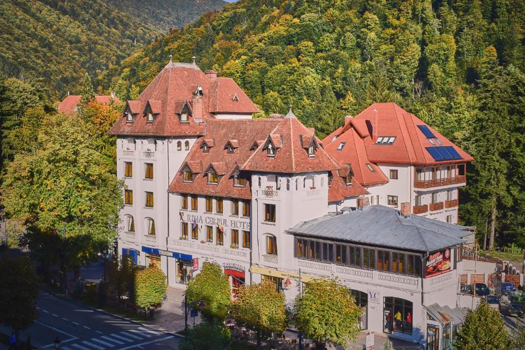 a large white building with a red roof at Hotel Rina Cerbul in Sinaia