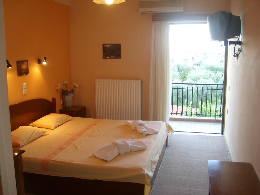 Postel nebo postele na pokoji v ubytování Hotel Themisto