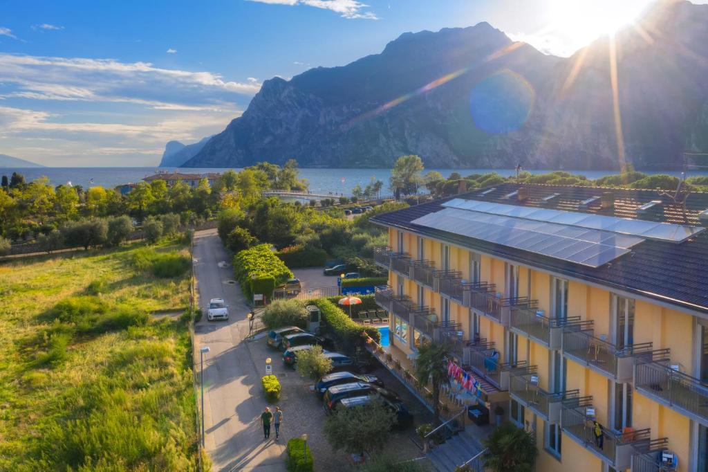 an aerial view of a building with mountains in the background at Hotel Roma in Nago-Torbole
