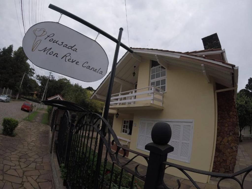 uma casa com um sinal que lê Villa Live Canyon em Pousada Lanai Canela em Canela