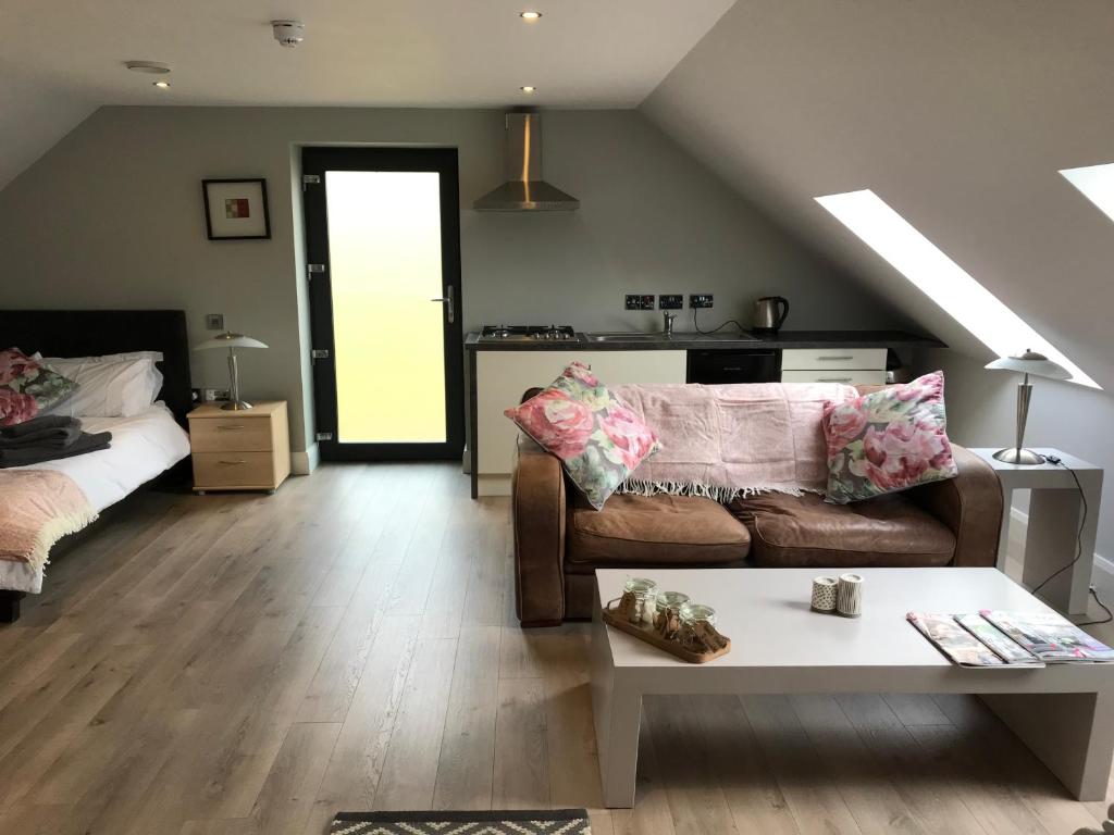 a living room with a couch and a table at Lakeside Studio 1 Loft Apartment in Enniskillen