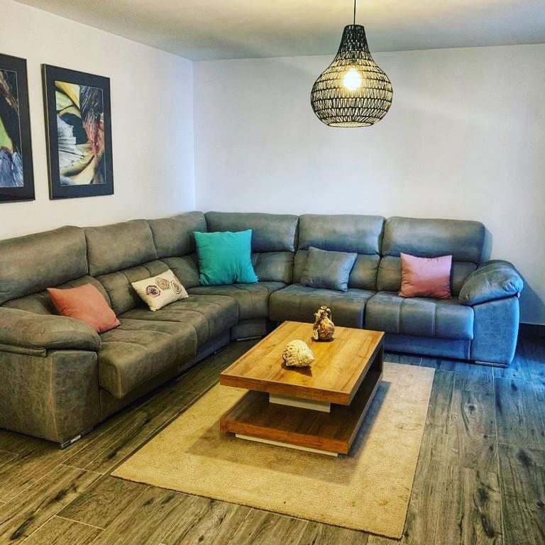a living room with a couch and a coffee table at Alojamientos 4nudos in San José