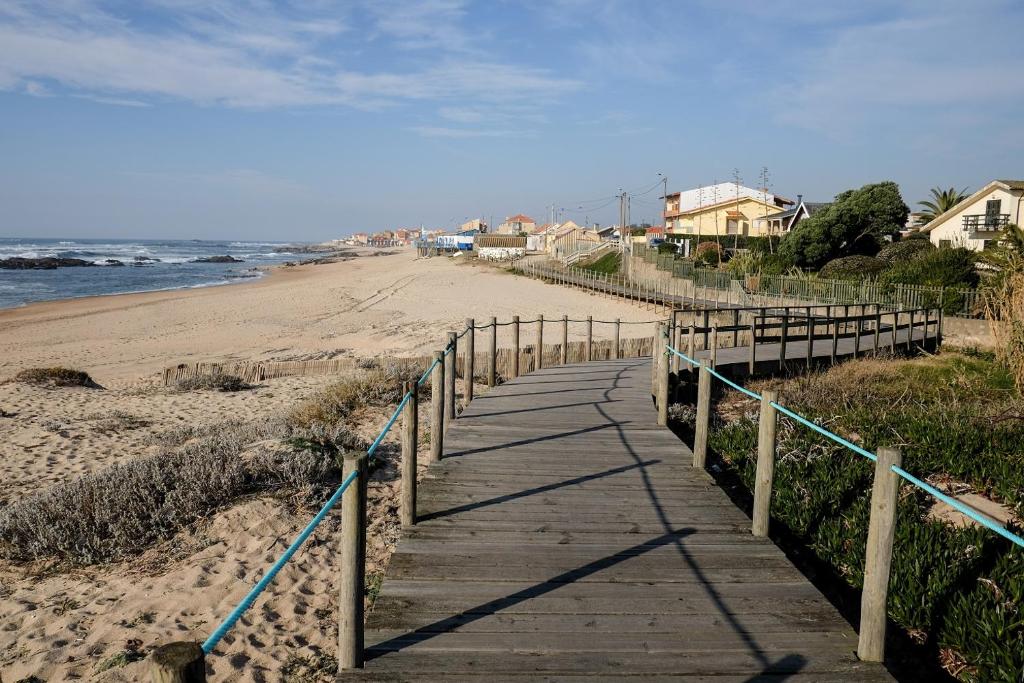 a wooden boardwalk leading down to the beach at my secret beach... in Vila Chã