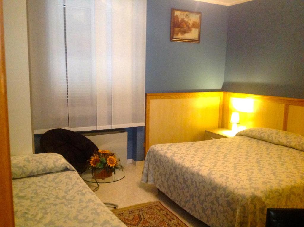 Postel nebo postele na pokoji v ubytování Hotel Monumento