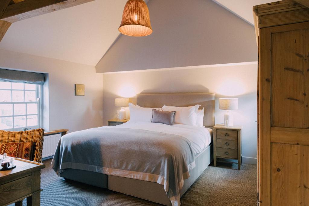 a bedroom with a large bed and a lamp at The Pointer in Brill