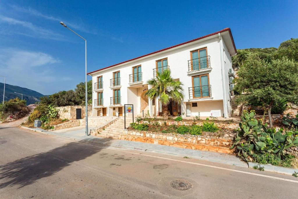 a white building on the side of a street at Medimar Hotel in Kaş