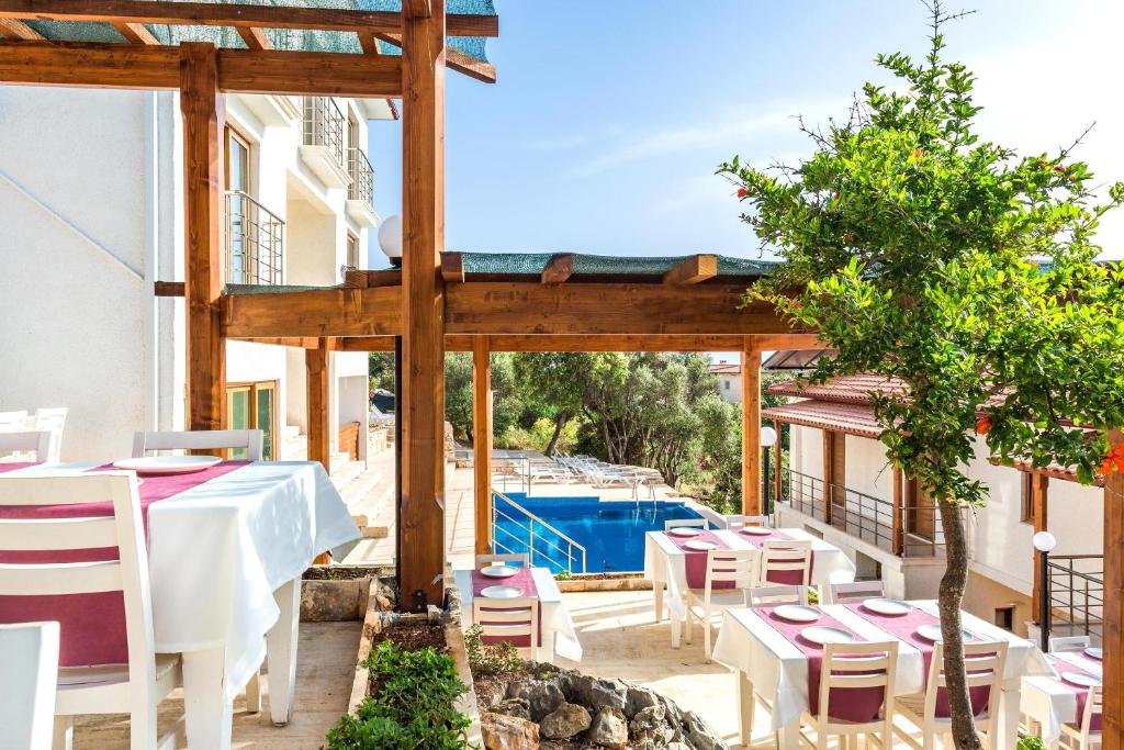 a restaurant with a table and chairs on a patio at Medimar Hotel in Kaş