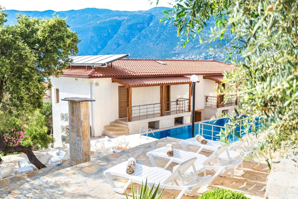 a villa with a view of the mountains at Medimar Hotel in Kaş