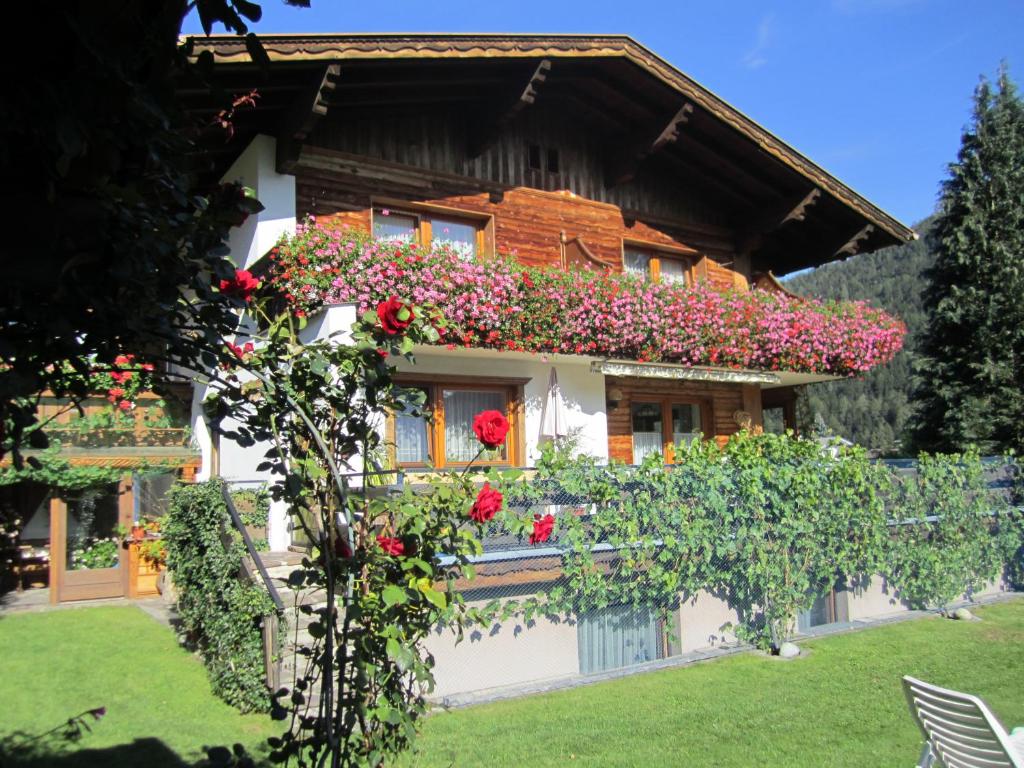 a house with flowers on the side of it at Haus Krößbacher in Fulpmes