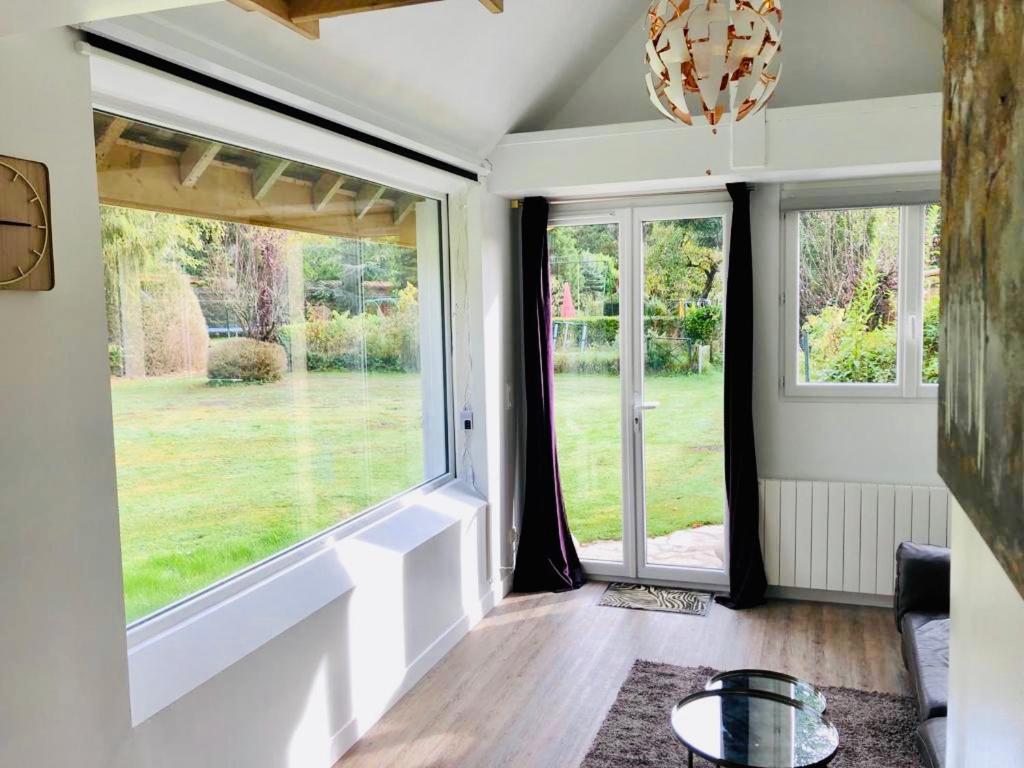 a living room with large windows and a couch at Ad libitum in Les Ageux