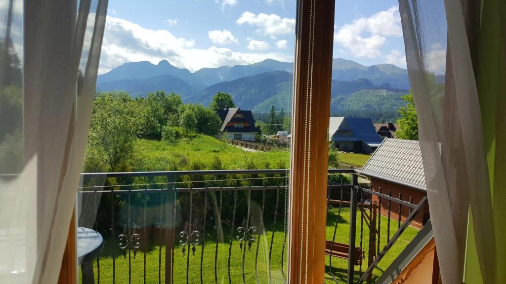 a view from a window of a mountain view at Apartament Kasprowy in Kościelisko