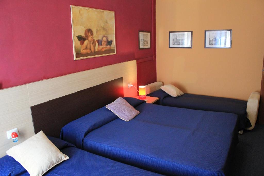 Postel nebo postele na pokoji v ubytování Hotel San Lorenzo