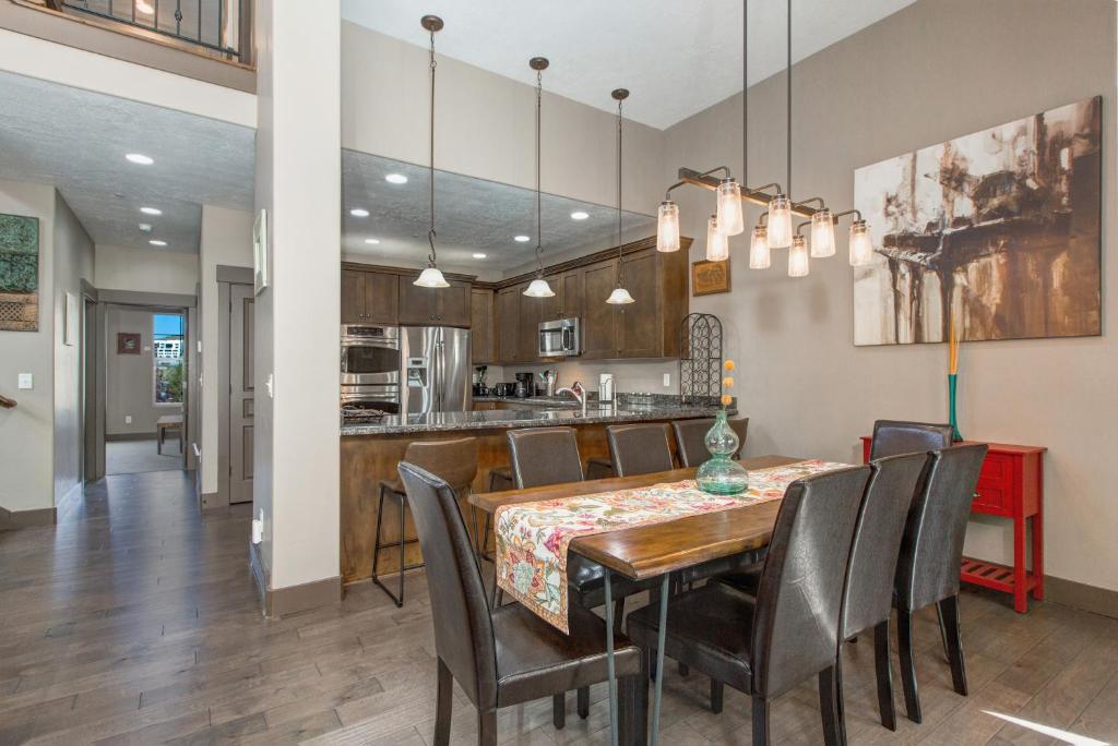 a dining room and kitchen with a table and chairs at Benjamin Place at Jordanelle in Kamas