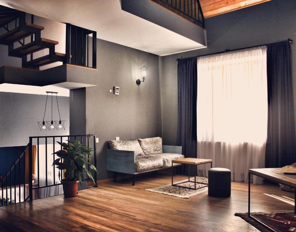 a living room with a couch and a chair at Villa Kazbegi in Stepantsminda