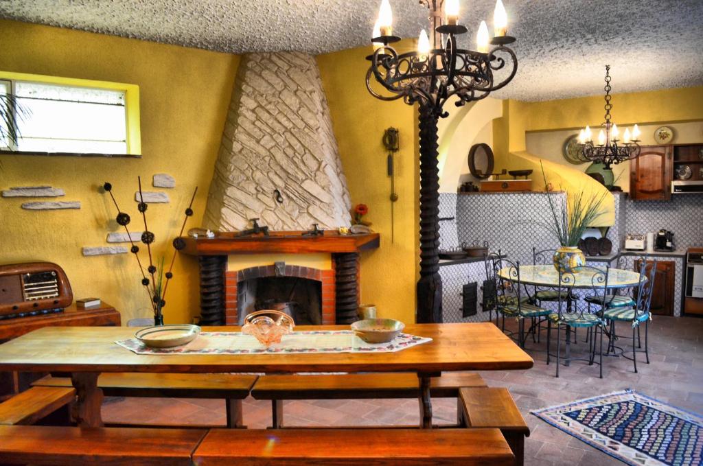 a living room with a table and a fireplace at B&B Aria Dell’' Etna in Zafferana Etnea