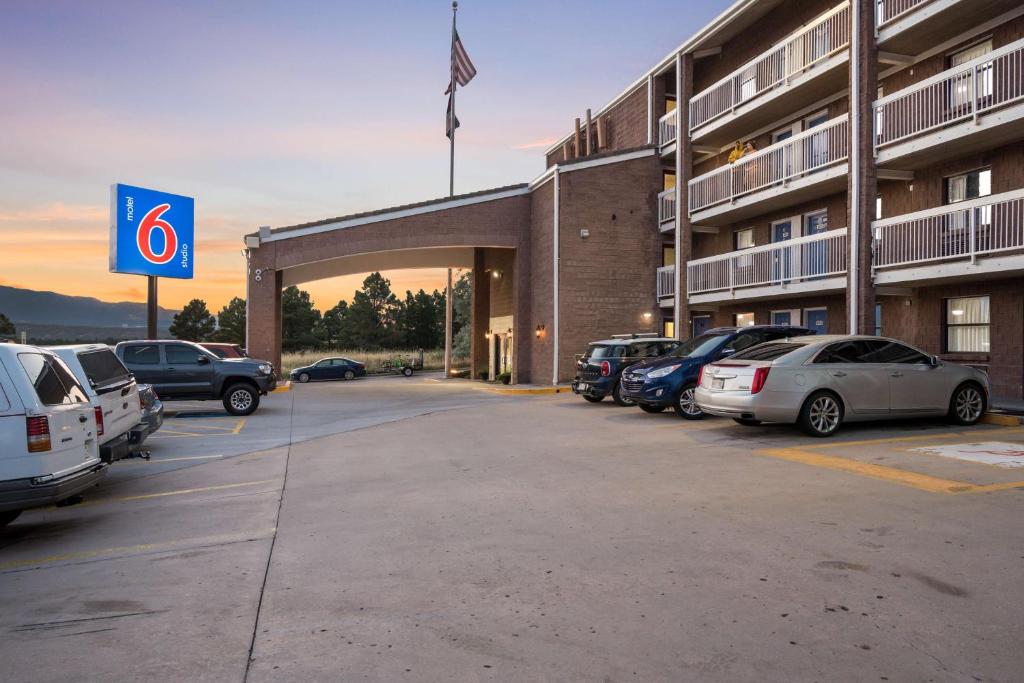 a parking lot with cars parked in front of a hotel at Studio 6 Colorado Springs, Colorado - Air Force Academy in Colorado Springs