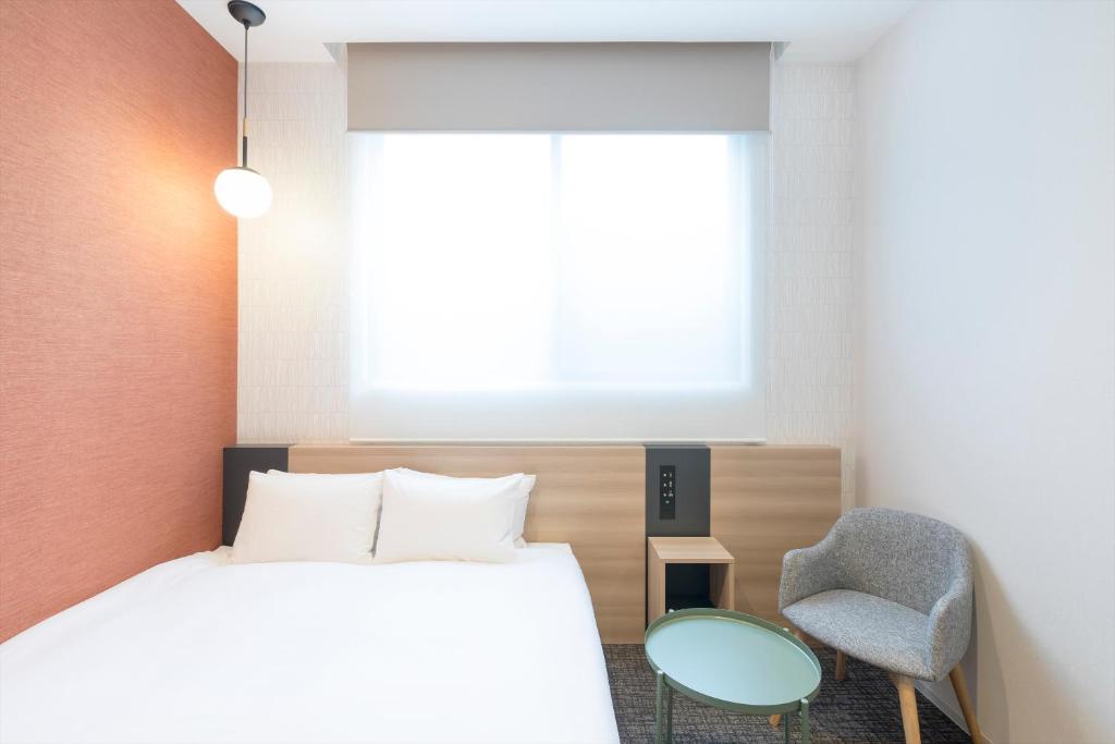 Postel nebo postele na pokoji v ubytování M's Hotel Sanjo Omiya