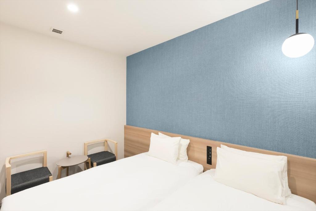 Postel nebo postele na pokoji v ubytování M's Hotel Sanjo Omiya