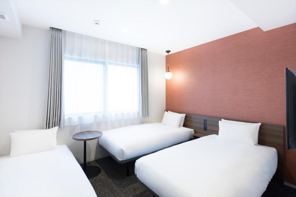 Postel nebo postele na pokoji v ubytování M's Hotel Sanjo Omiya