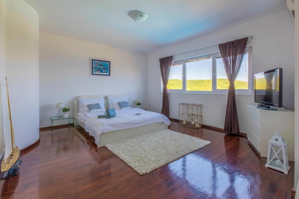Postel nebo postele na pokoji v ubytování Villa Vrbnik