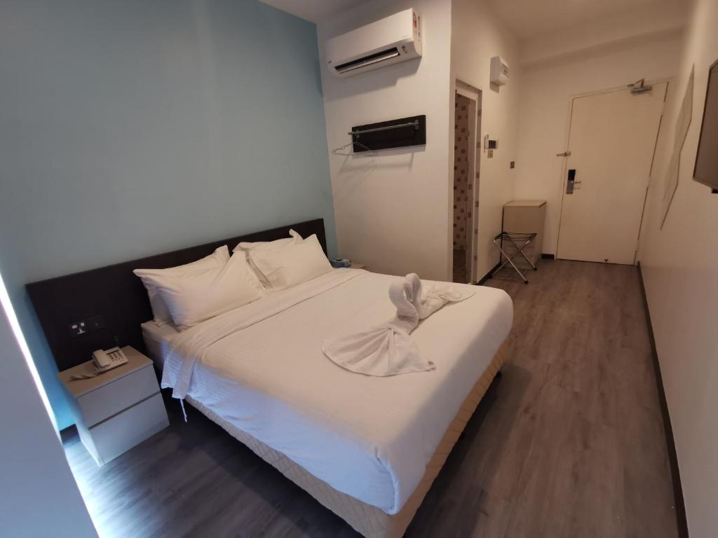Postel nebo postele na pokoji v ubytování TT Dorf Hotel Taiping