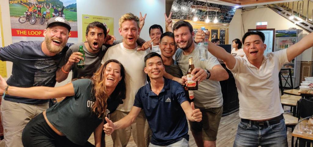 a group of people posing for a picture at Ha Giang Donkey hostel in Ha Giang