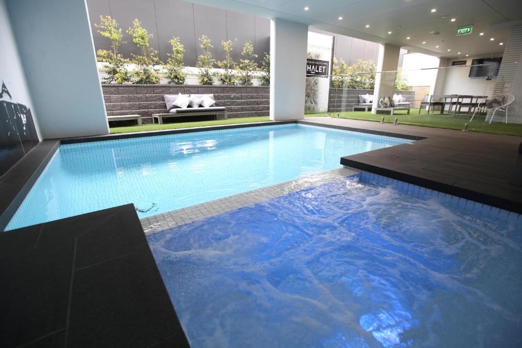 a large swimming pool with blue water in a house at Ocean Grove Chalet in Ocean Grove