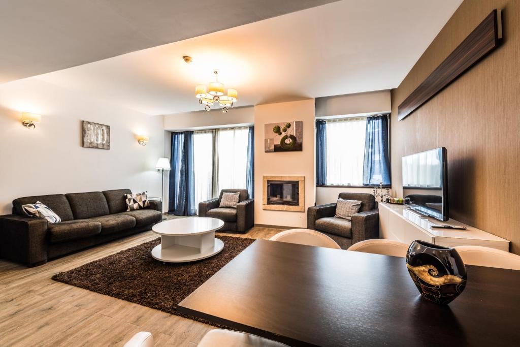 a living room with a couch and a table at Silver Mountain Apartment 26 in Poiana Brasov