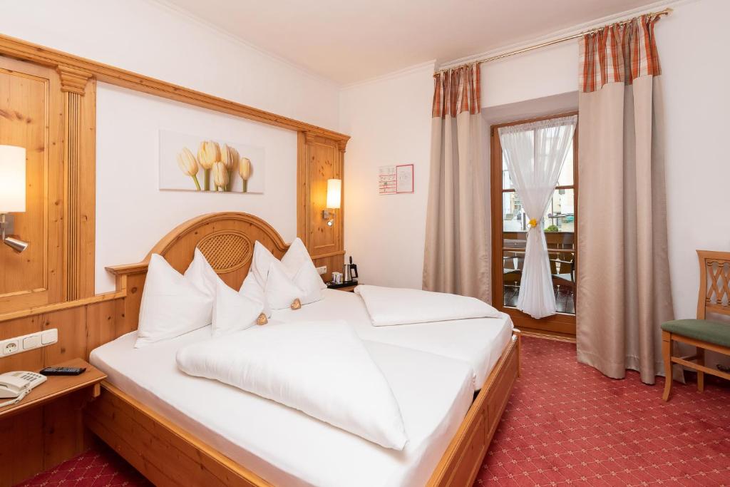 Postel nebo postele na pokoji v ubytování Hotel Zimmerbräu