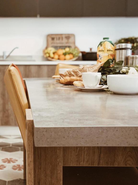 a kitchen counter with a table with food on it at Hammock Vibes Town House in Sliema