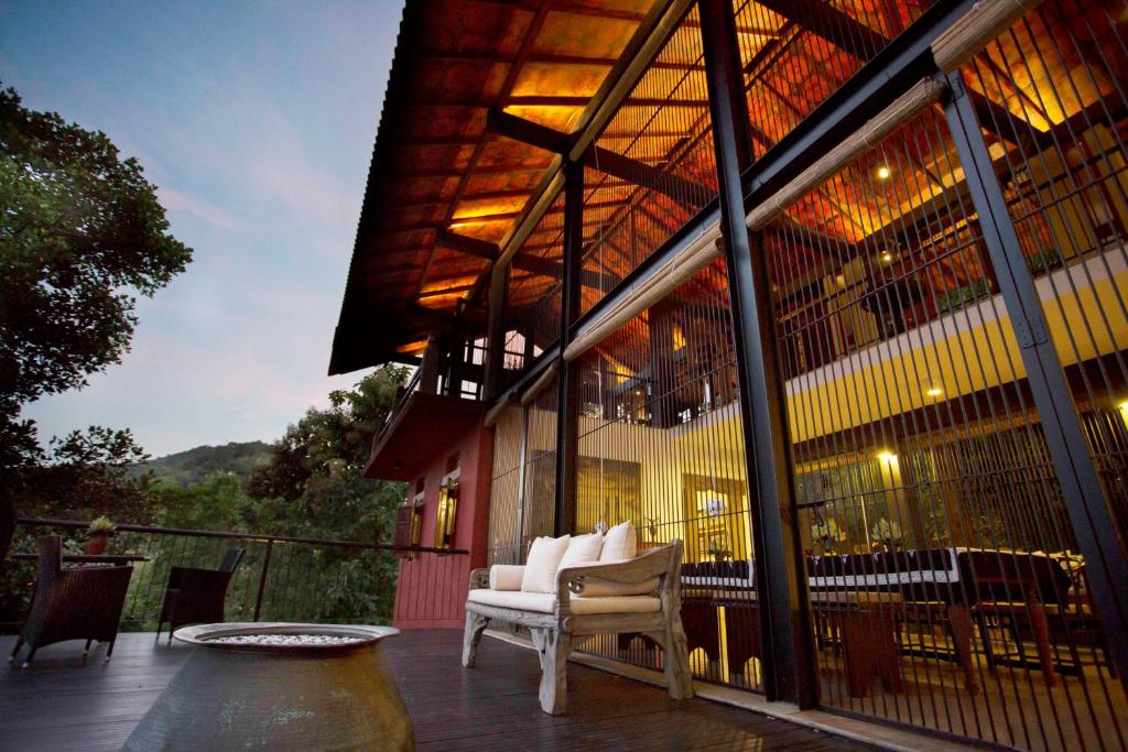 a building with a patio with a table and chairs at The Hermitage by Edwards Collection in Haragama