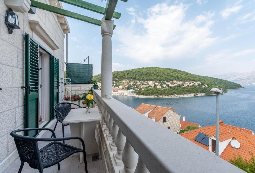 a balcony with chairs and a view of the water at Apartments Darija in Pučišća