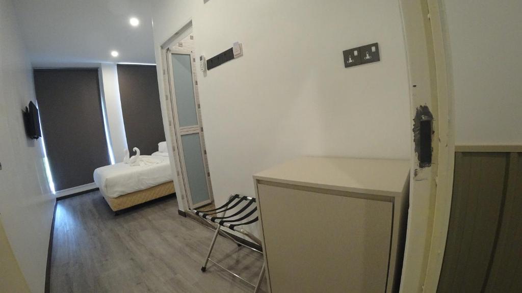Postel nebo postele na pokoji v ubytování TT Dorf Hotel Taiping