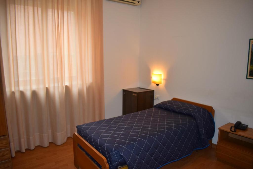 Postel nebo postele na pokoji v ubytování Hotel Principe