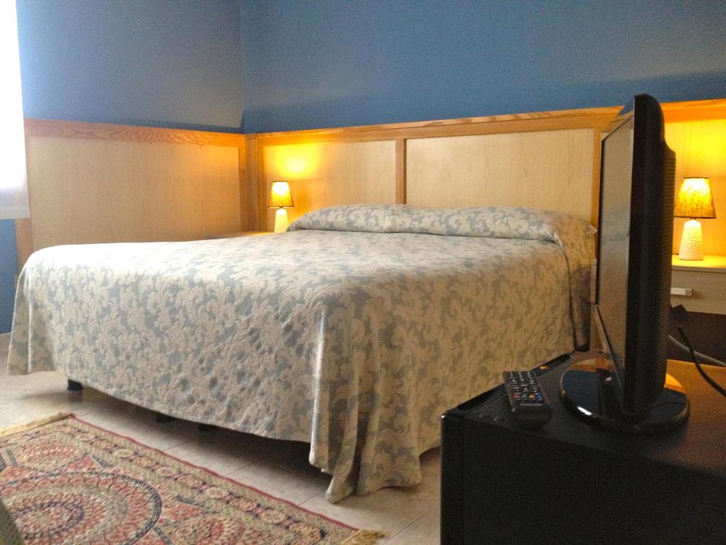 Postel nebo postele na pokoji v ubytování Hotel Monumento