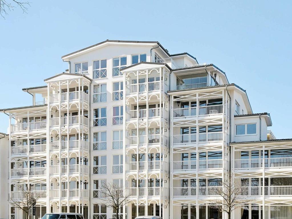 a white apartment building with balconies on it at Two-Bedroom Holiday home in Großenbrode 14 in Großenbrode