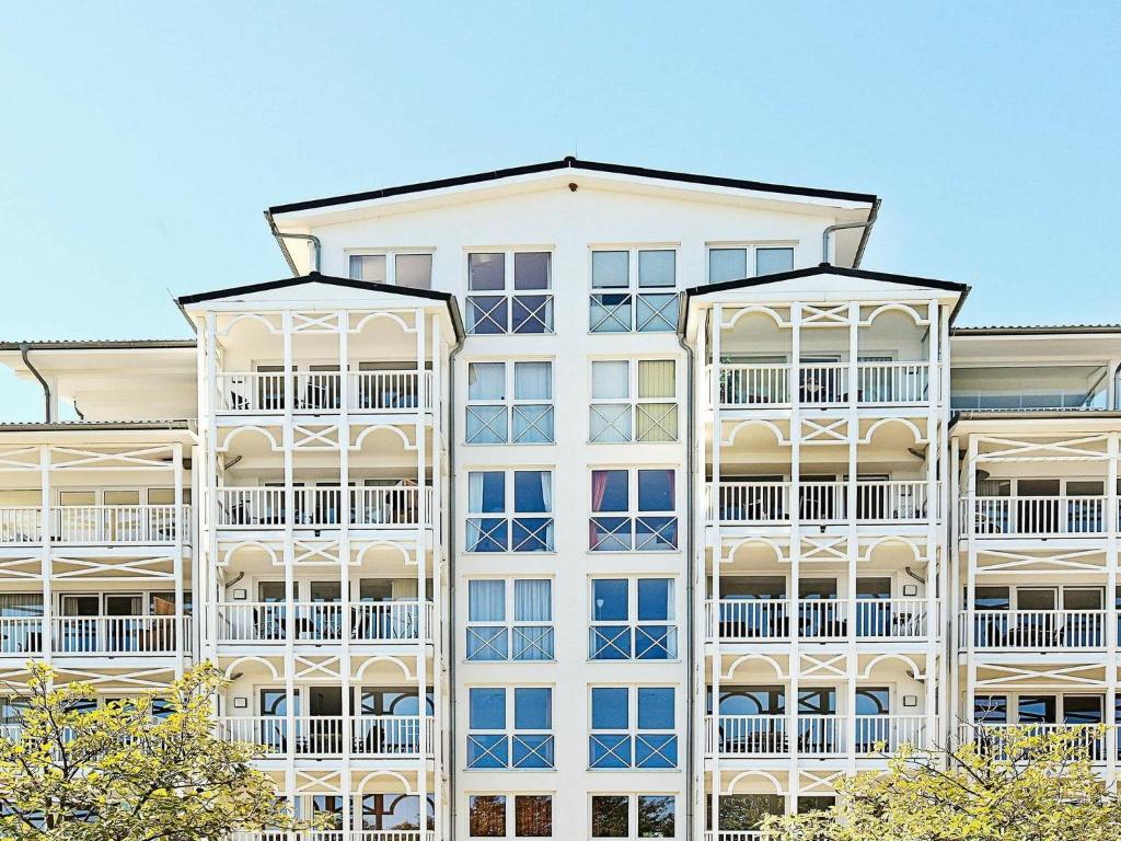 a tall white apartment building with white balconies at Two-Bedroom Holiday home in Großenbrode 12 in Großenbrode