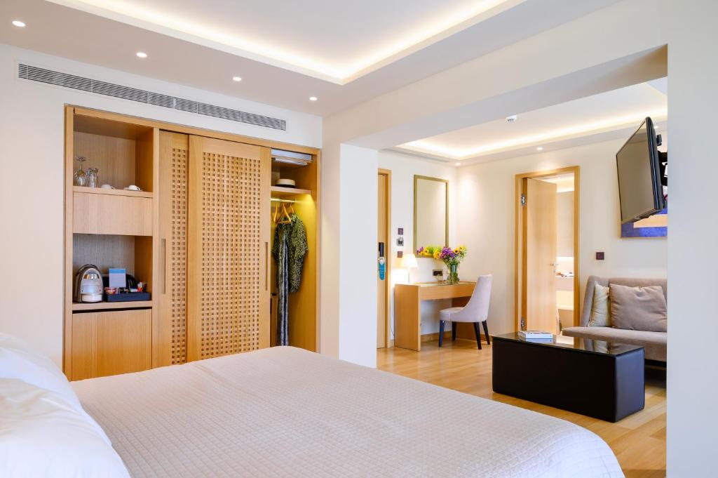 a bedroom with a bed and a living room at Somewhere Vouliagmeni in Athens