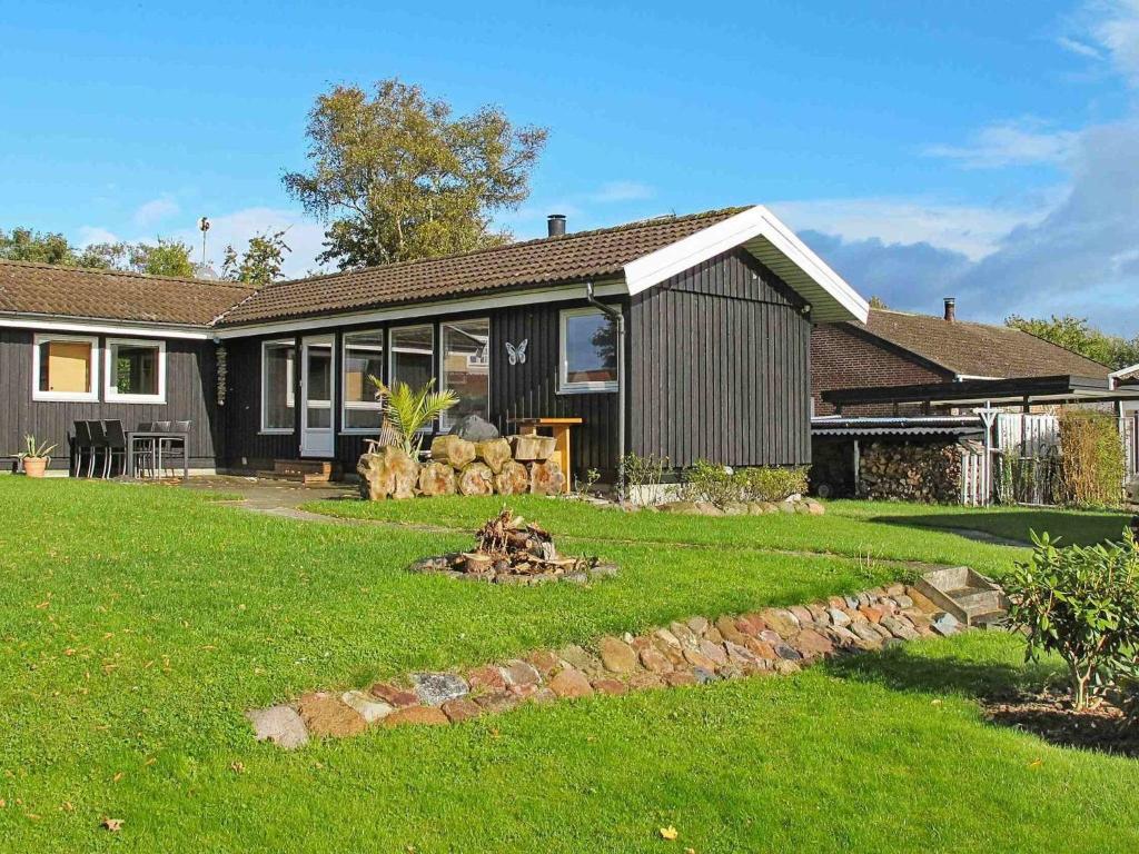 a house with a yard with a yard at 6 person holiday home in Str by in Strøby
