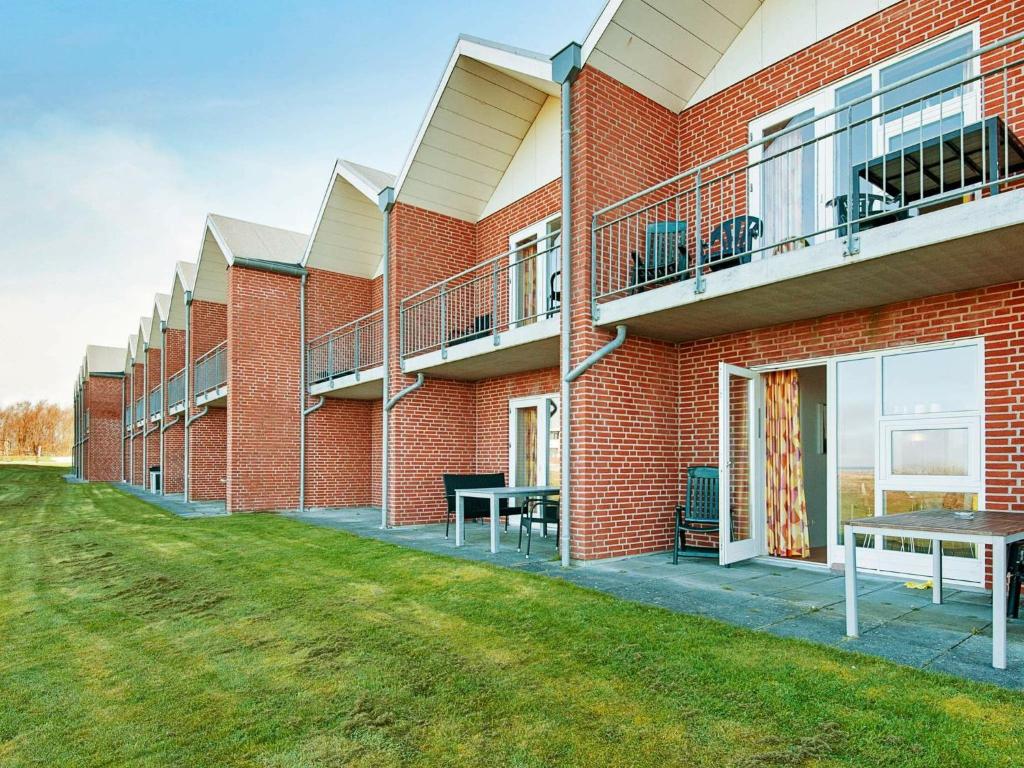 a red brick building with a picnic table in front of it at Beautiful Holiday Home in HÃ¸jer with Terrace in Emmerlev