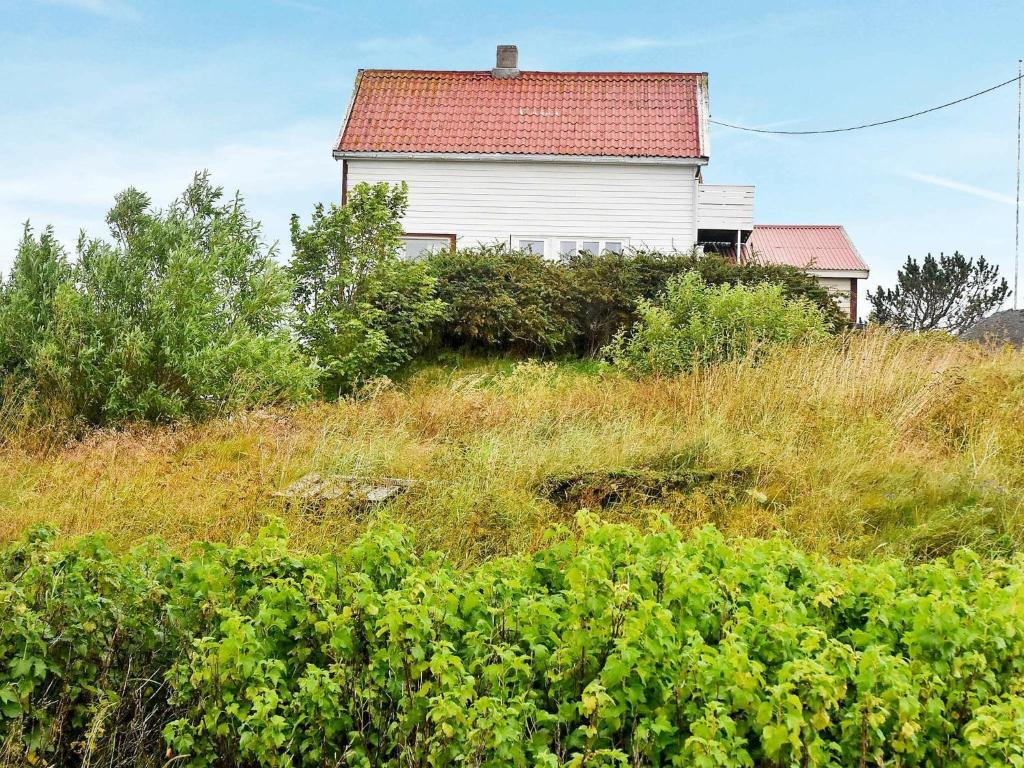 a house sitting on top of a grassy hill at 6 person holiday home in Dyrvik in Dyrvik