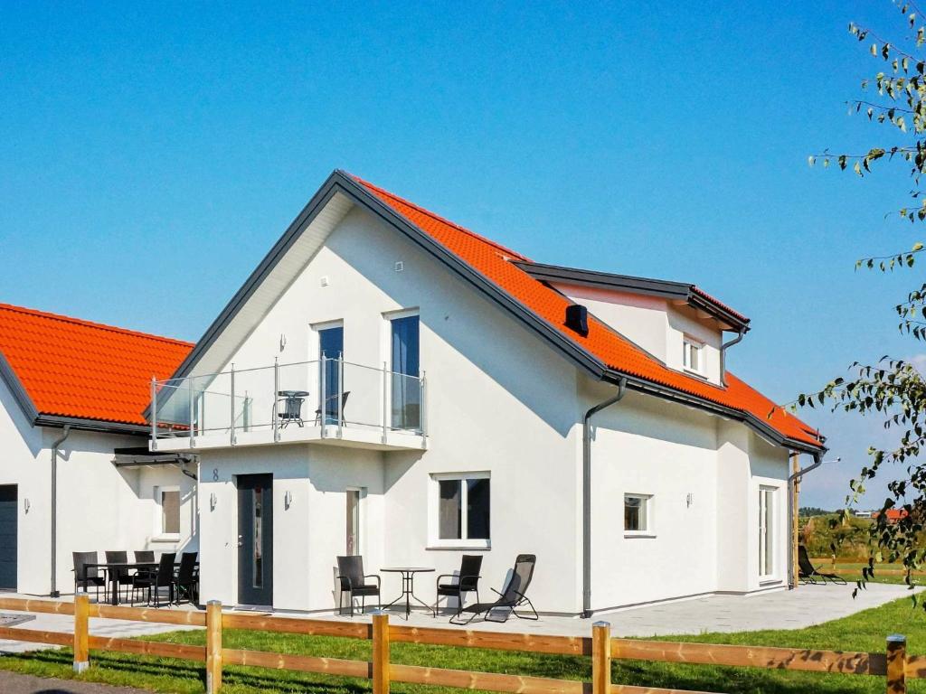 ファルケンベリにある8 person holiday home in GLOMMENのオレンジ色の屋根の白い家