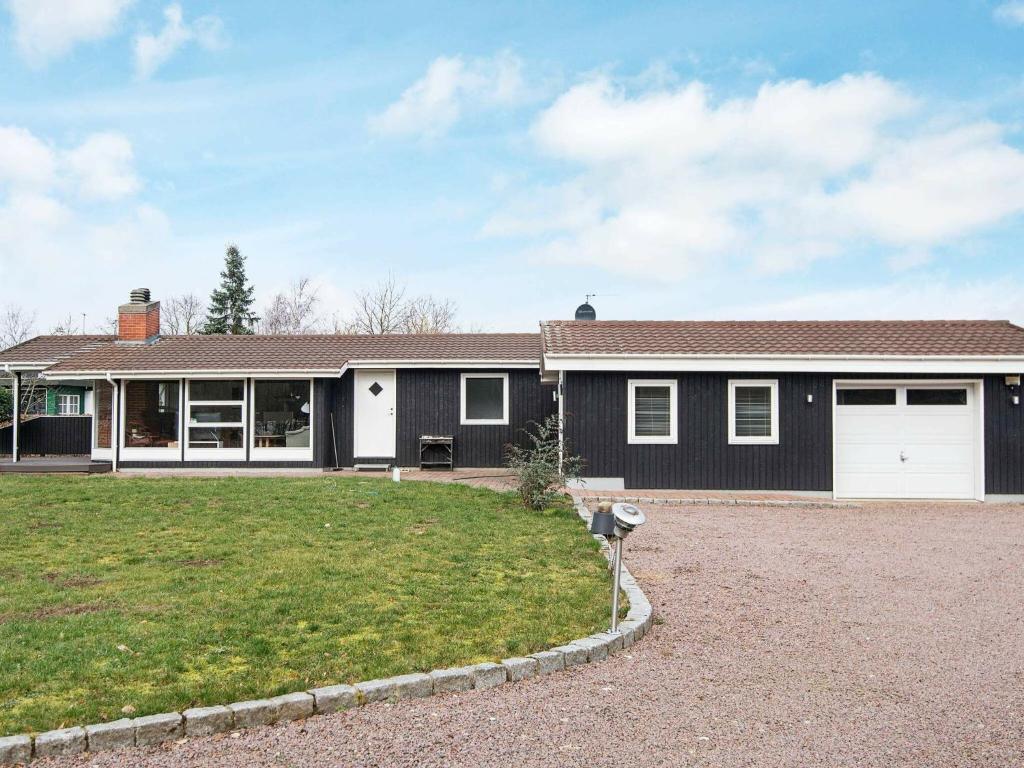 a house with a garage and a yard at 6 person holiday home in Silkeborg in Silkeborg