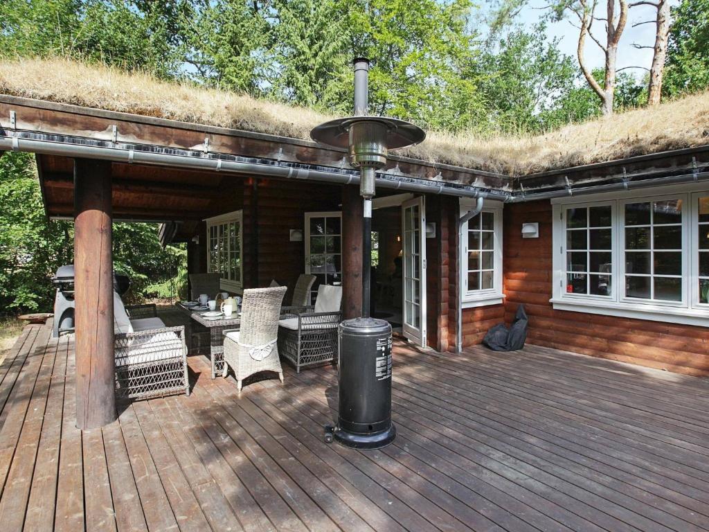 a large wooden deck with a grass roof at 8 person holiday home in Frederiksv rk in Frederiksværk